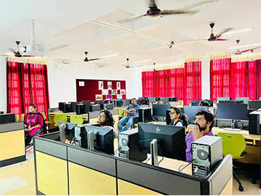 Two men in bicycle jerseys sitting outside at table having coffee